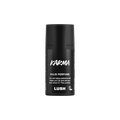 Karma. A short, cylindrical black push-up tube of the Karma solid perfume with a black label on the front covering the cap, with the product name and scent printed on it.