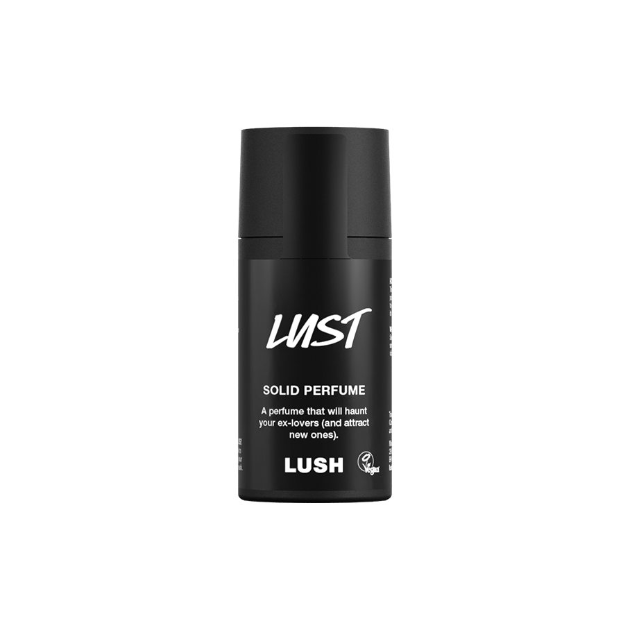 Lust. A short, cylindrical black push-up tube of the Lust solid perfume with a black label on the front covering the cap, with the product name and scent printed on it.